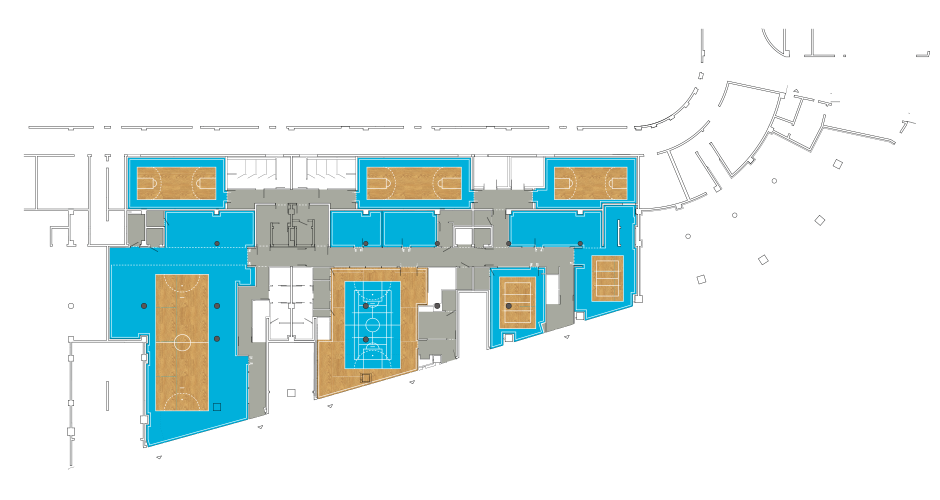'.Plan du rez de chaussée. <br/>En bleu les zones « Terrain » réservées aux bureaux, en gris les zones de circulation.<br/>
L'espace d'accueil est sur une surface type parquet et reprend le marquage au sol de tous les terrains.
<br/><br/><br/><br/>.'
